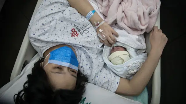 Woman with newborn baby in hospital in Wuhan