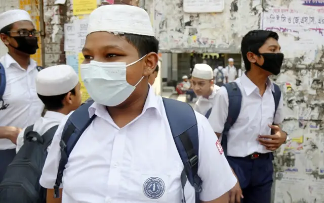 A Bangladeshi school student wears a protective mask as he attend a class in Dhaka, Bangladesh