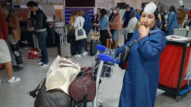 Passengers wait for their flights at the Marrakesh Airport in Morocco on 15 March 2020