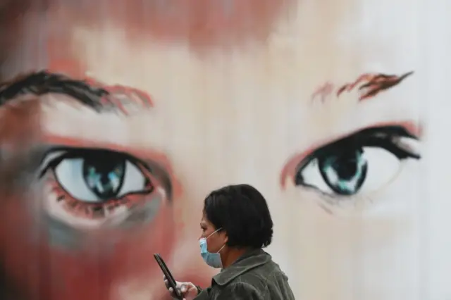 A woman walks past a hospital in Madrid