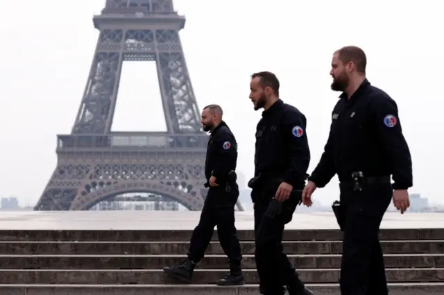 French police patrol at the Tocadero square near the Eiffel tower in Paris as a lockdown imposed to slow the rate of the coronavirus disease