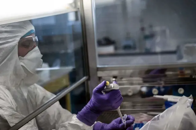 Image shows a French scientist working to produce a new vaccine against coronavirus