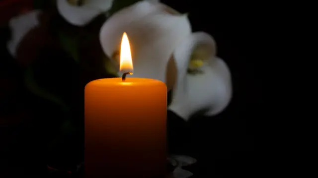 Candle lit at funeral