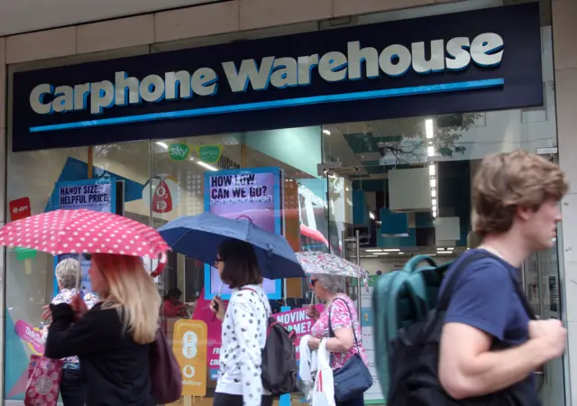 People outside a Carphone Warehouse store