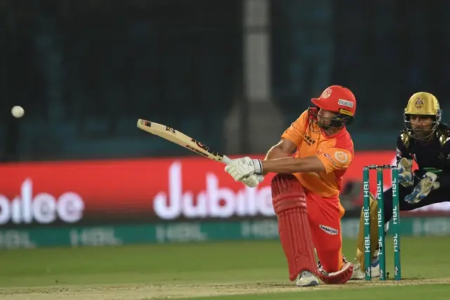 Dawid Malan (L) of Islamabad United plays a shot as Quetta Gladiators wicketkeeper Sarfraz Ahmed (R) looks on during the Pakistan Super League (PSL) Twenty20 cricket match between Quetta Gladiators and Islamabad United at the National Cricket Stadium in Karachi on February 20, 2020.