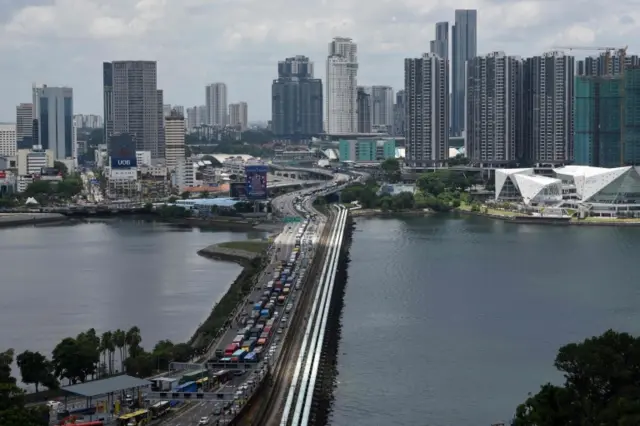 Cars queue at the Singapore-Malaysia border