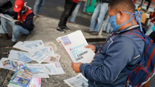 A man in Caracas, Venezuela, reads the latest news about the coronavirus on 17 March