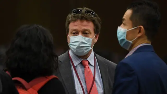 New York Times Beijing bureau chief Steven Lee Myers (C) speaks with other journalists after the daily Foreign Ministry briefing in Beijing on March 18, 2020