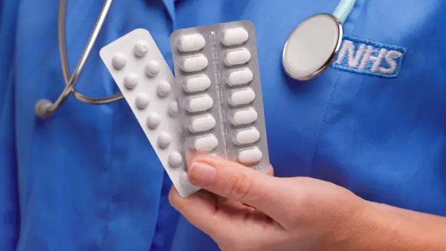 Nurse holding pills