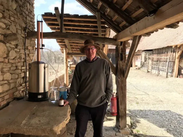 Jim Turnbull with the tank he uses to make the sanitiser