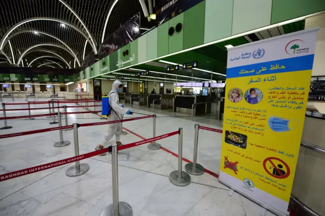 A worker disinfects part of Baghdad International Airport on 17 March 2020