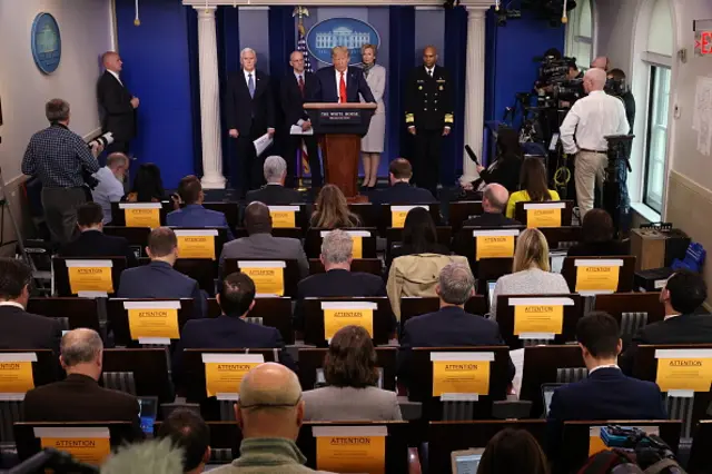 US President Donal Trump, flanked by Coronavirus Task Force members, gives an update on the coronavirus outbreak from the White House press room