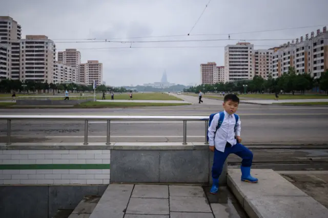 A boy stands at the entrance to an underpass beside a road in Pyongyang on June 19, 2019. (