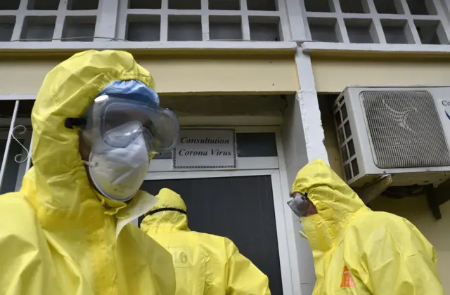 Algerian paramedics wearing protective outfits in front of El-Kettar hospital in Algiers