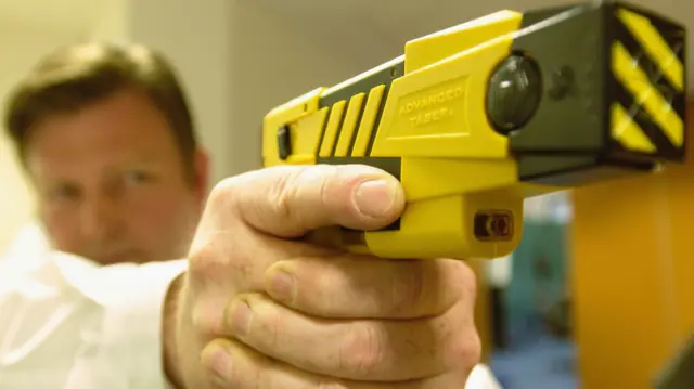 A person with a Taser