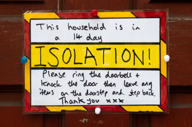 A sign saying a family are in isolation