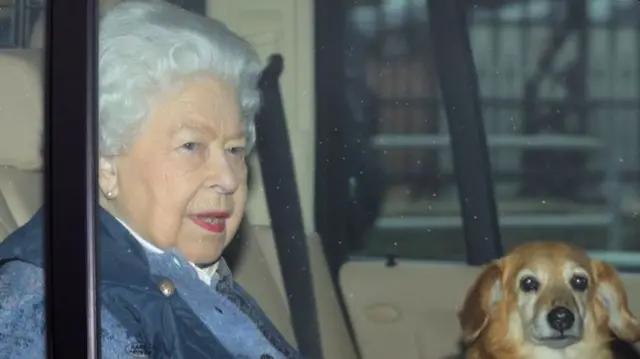 The Queen with one of her corgis, leaving Buckingham Palace