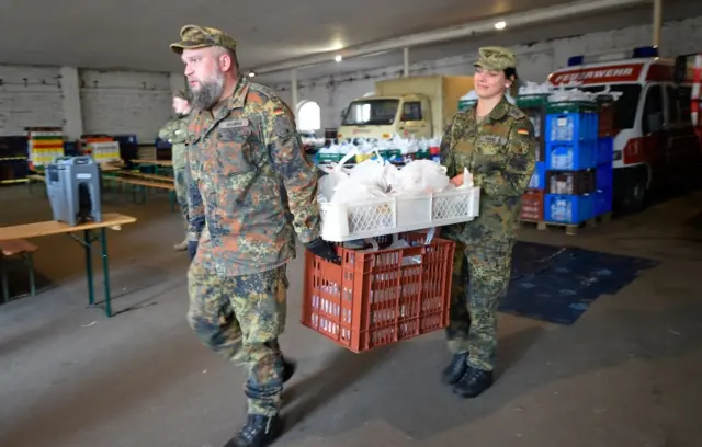 Soldiers of the German armed forces Bundeswehr prepare food supply for truck drivers trapped in a traffic jam on the A4 highway