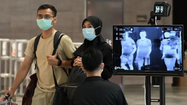 People have their temperature checked in Singapore