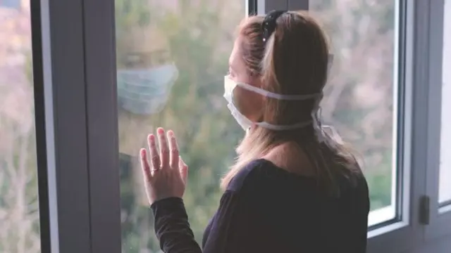 Woman self-isolating in her home