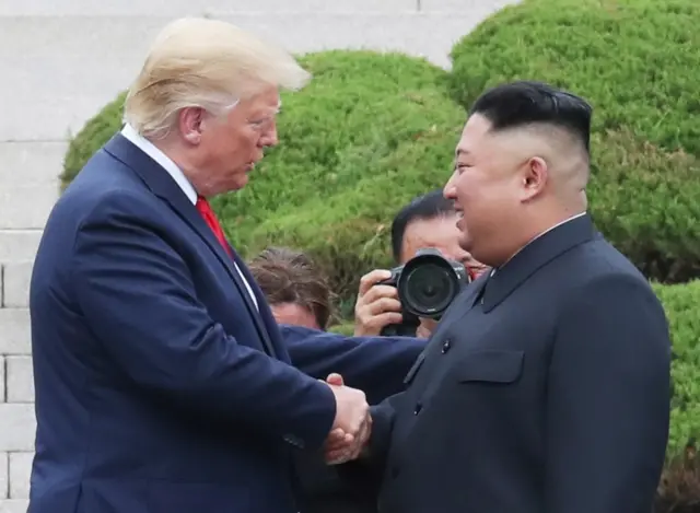 US President Donald Trump (left) and North Korean leader Kim Jong-un shake hands during a meeting in June 2019