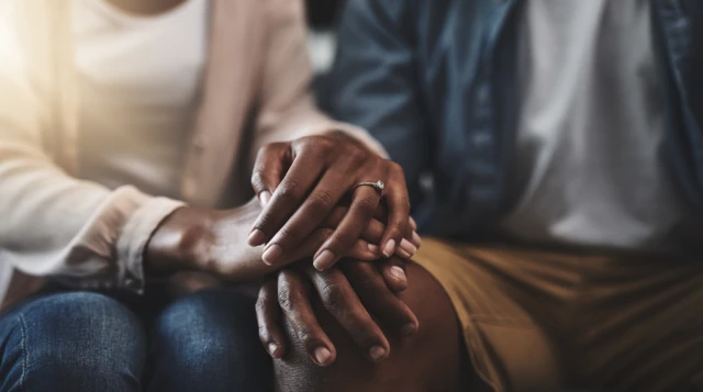 Stock image of a couple holding hands