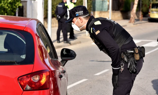 Police officer at a vehicle checkpoint in Spain