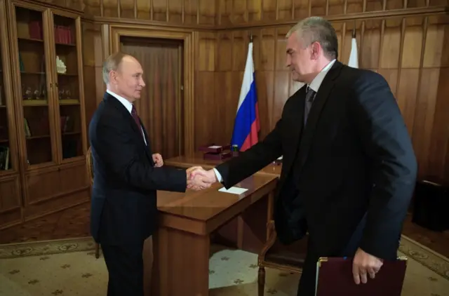 Russian President Vladimir Putin (left) shakes hands with a Moscow-appointed official in the Russia-annexed Crimea. Photo: 19 March 2020