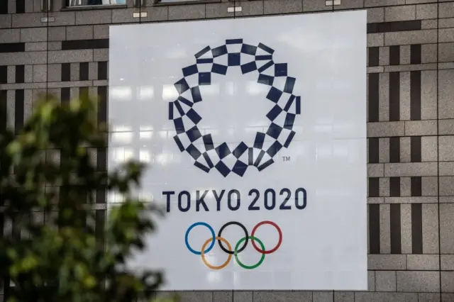 A Tokyo 2020 Olympics banner is displayed on a building