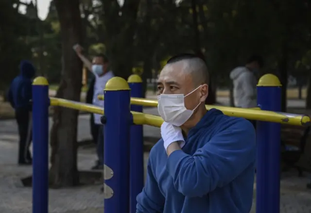 Picture of a man in China wearing a mask