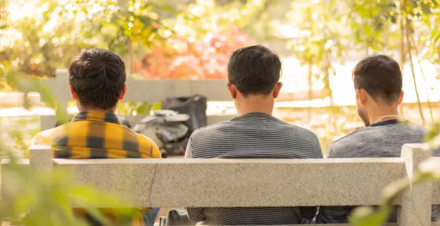 Three young people in park