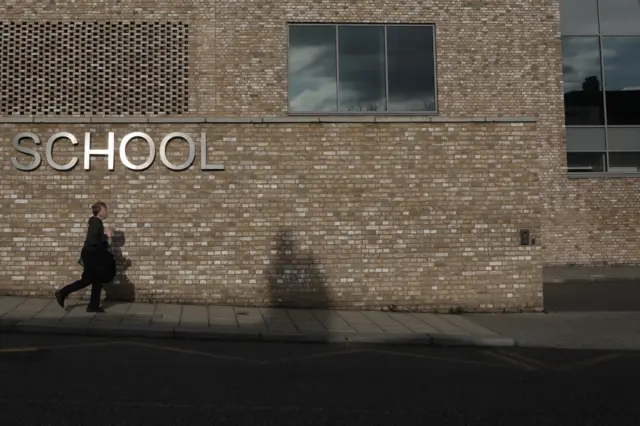 A child walks past a school