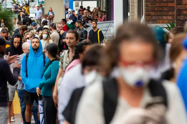 A long queue of people waiting for government assistance in Sydney, Australia