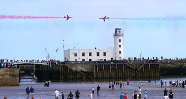 Red Arrows fly over Scarborough lighthouse