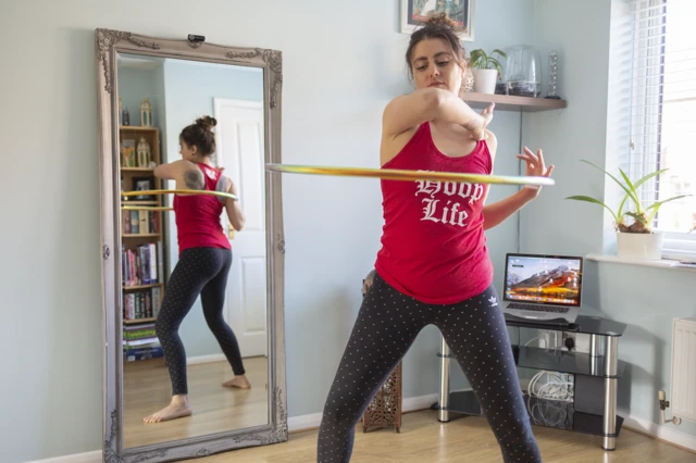 Rochene hooping in her living room