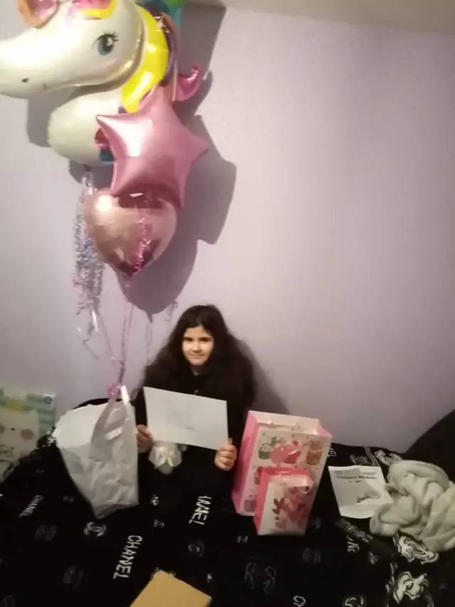 Aaliyah with her balloon and gifts