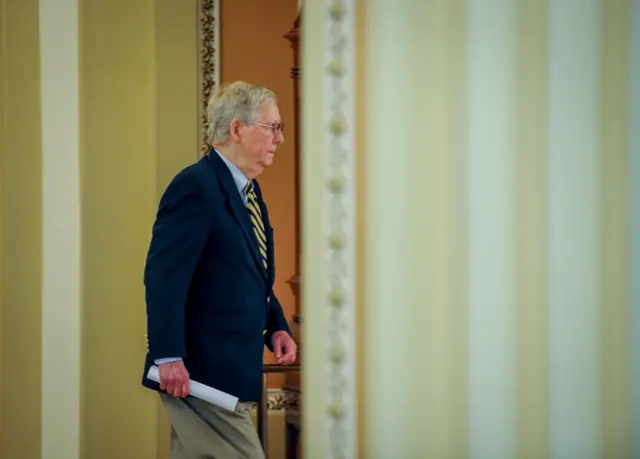 US Senate Majority Leader Mitch McConnell returns to his office after speaking to the media