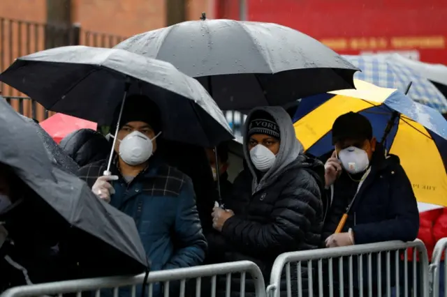 People queue at the Elmhurst Hospital Center to be tested for the coronavirus disease in Queens, New York City