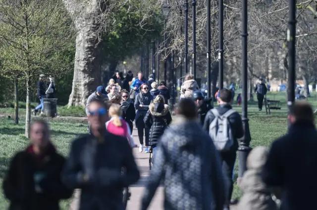 People are seen walking on Clapham Common