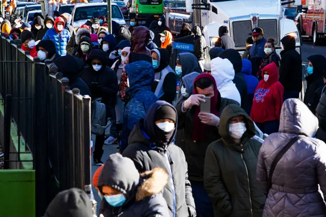 People line up outside Elmhurst Hospital to get tested due to coronavirus outbreak on 24 March 2020 in Queens, New York City