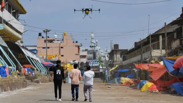 A drone is used to spray disinfectant during a government-imposed lockdown at Krishna Rajendra Market in Bangalore, 24 March 2020