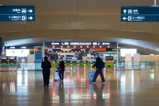 Passengers arrive at Wuhan Railway Station in Wuhan, China, on 24 March 2020