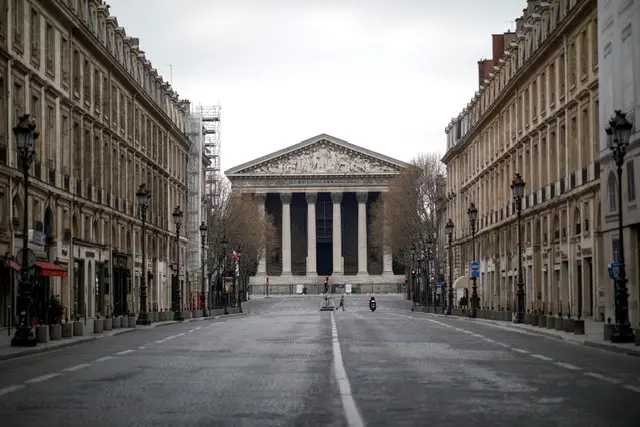 A view shows the Madeleine church at the top of an almost deserted rue Royale in Paris on 22 March 2020