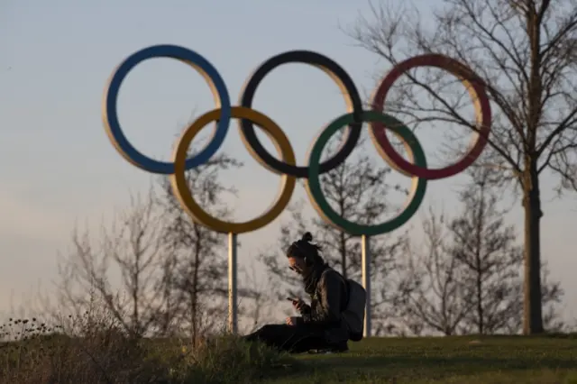 A man sits alone at the Olympic Park, Stratford, east London