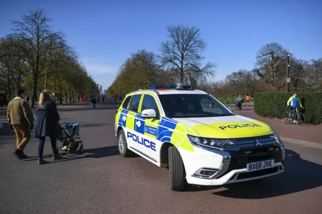 A Police car is seen parked at the gates to Greenwich Park