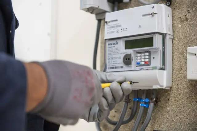 SMS worker installing meter