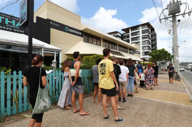 A large queue of people outside a Centrelink office in Sydney, Australia