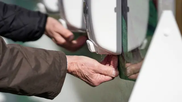 Man using hand sanitiser