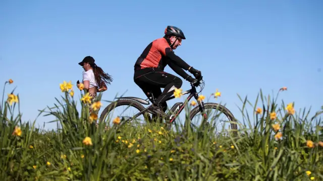 Biker and runner in Guilford Park, 25 March