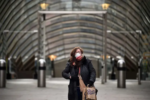 woman in mask by subway station